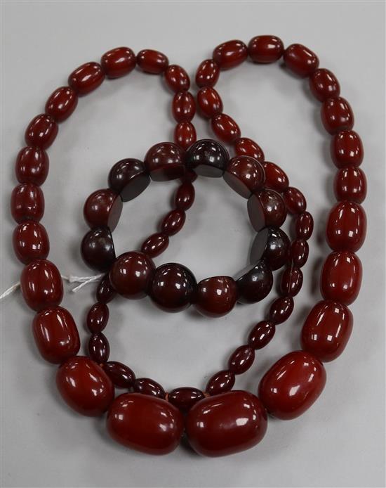 A single strand graduated simulated cherry amber necklace and a similar bracelet.